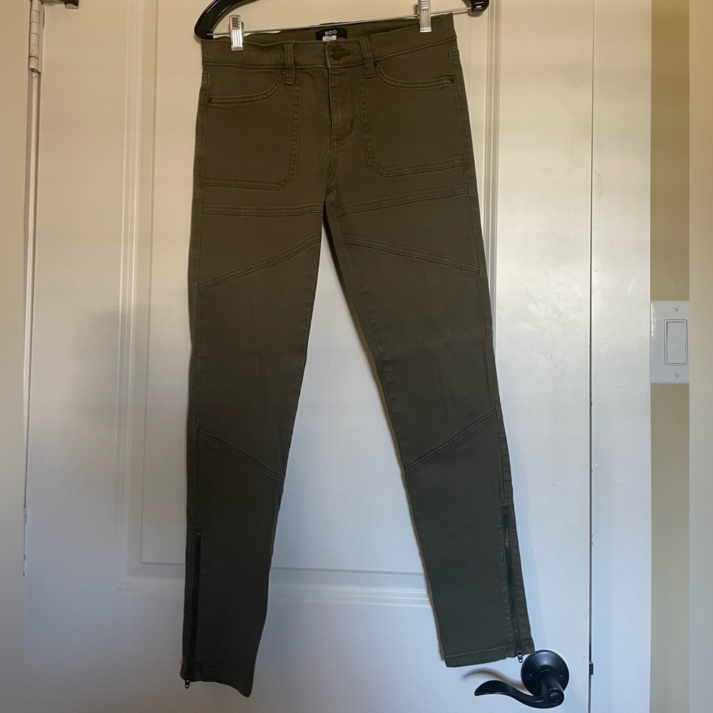 Olive green jeans with zipper detail at the bottom